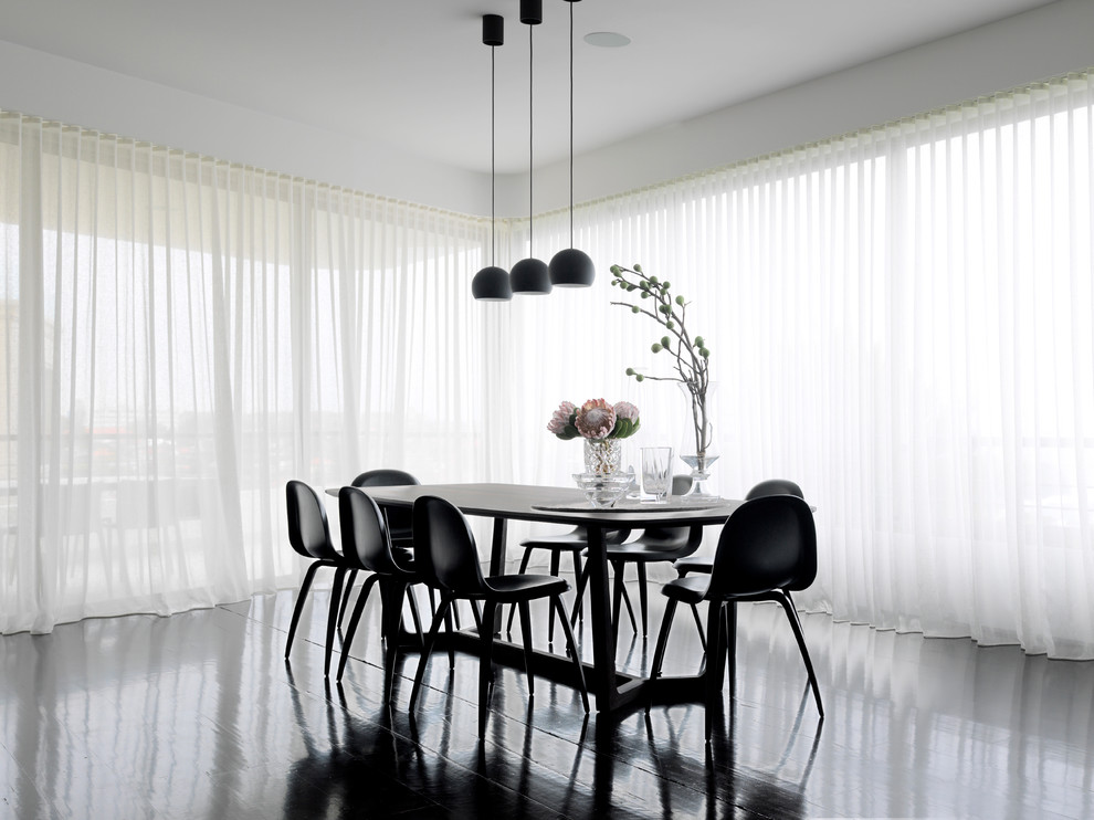 Contemporary dining room in Sydney with white walls, dark hardwood floors and no fireplace.