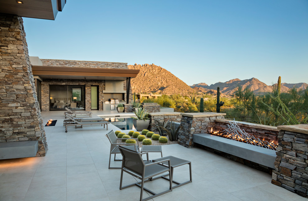 Design ideas for a patio in Phoenix with concrete pavers and no cover.