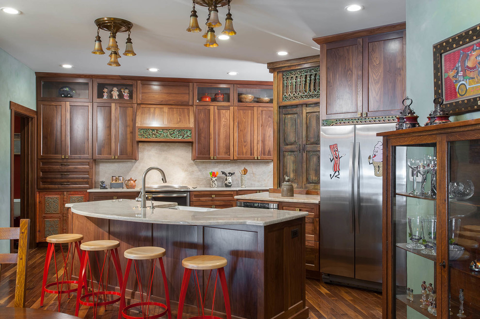 Photo of an eclectic kitchen in St Louis with a farmhouse sink, shaker cabinets, medium wood cabinets, granite benchtops, stainless steel appliances and medium hardwood floors.