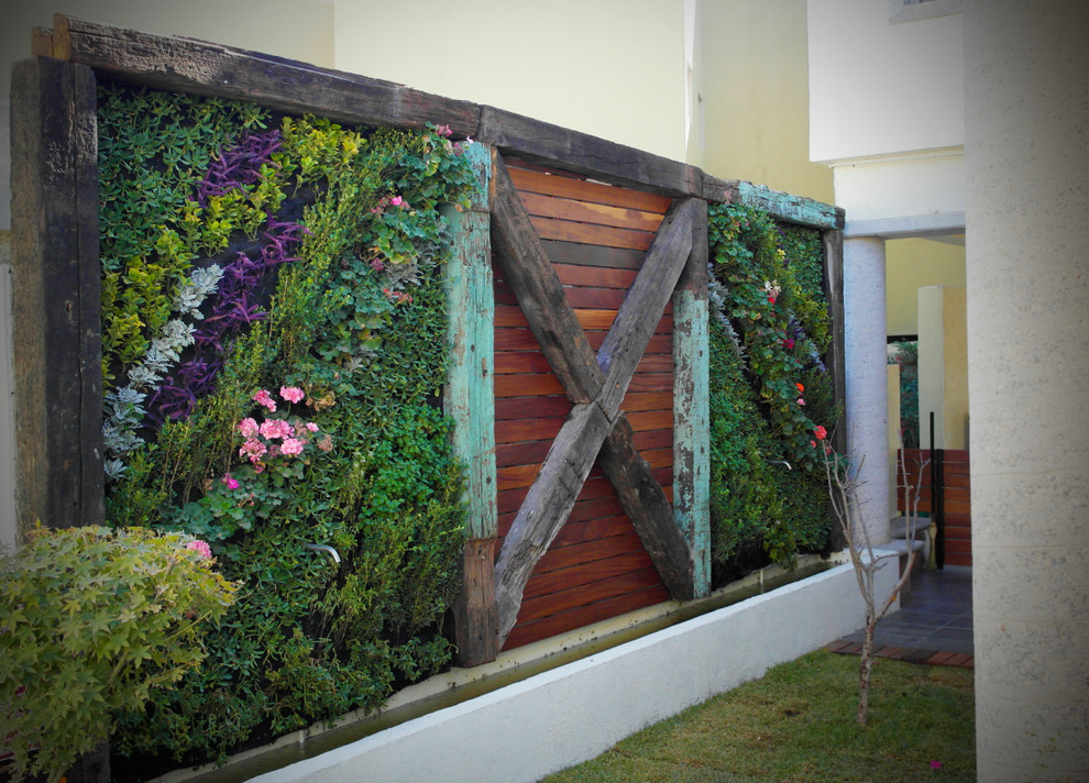 Inspiration for a mid-sized eclectic side yard partial sun driveway with a vertical garden.
