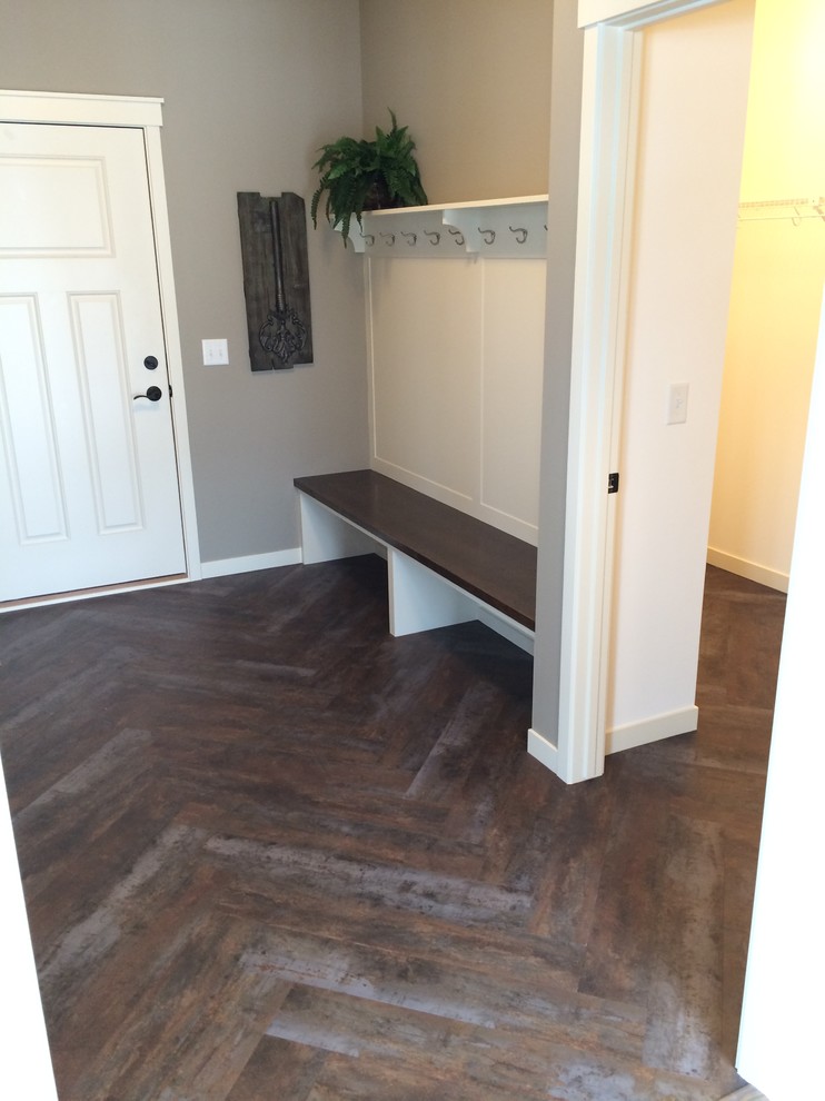 Photo of a mid-sized transitional mudroom in Minneapolis with grey walls, dark hardwood floors, a single front door and a white front door.