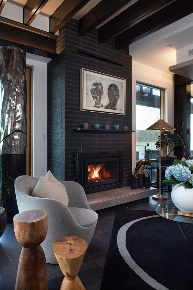Inspiration for a large contemporary living room in Seattle with white walls, a standard fireplace, a brick fireplace surround, grey floor and exposed beam.