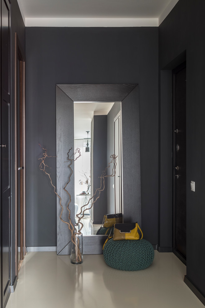 Photo of a contemporary entry hall in Moscow with black walls, a single front door, a black front door and beige floor.