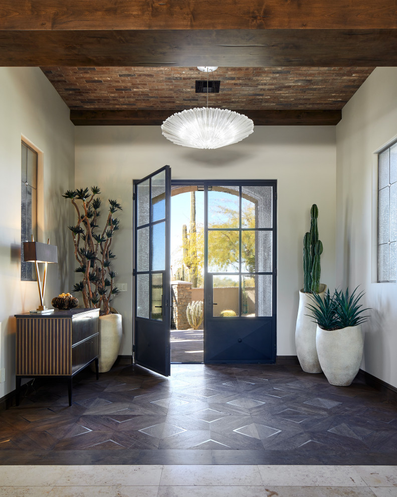 Inspiration for a large foyer in Phoenix with white walls, a double front door, a black front door and exposed beam.