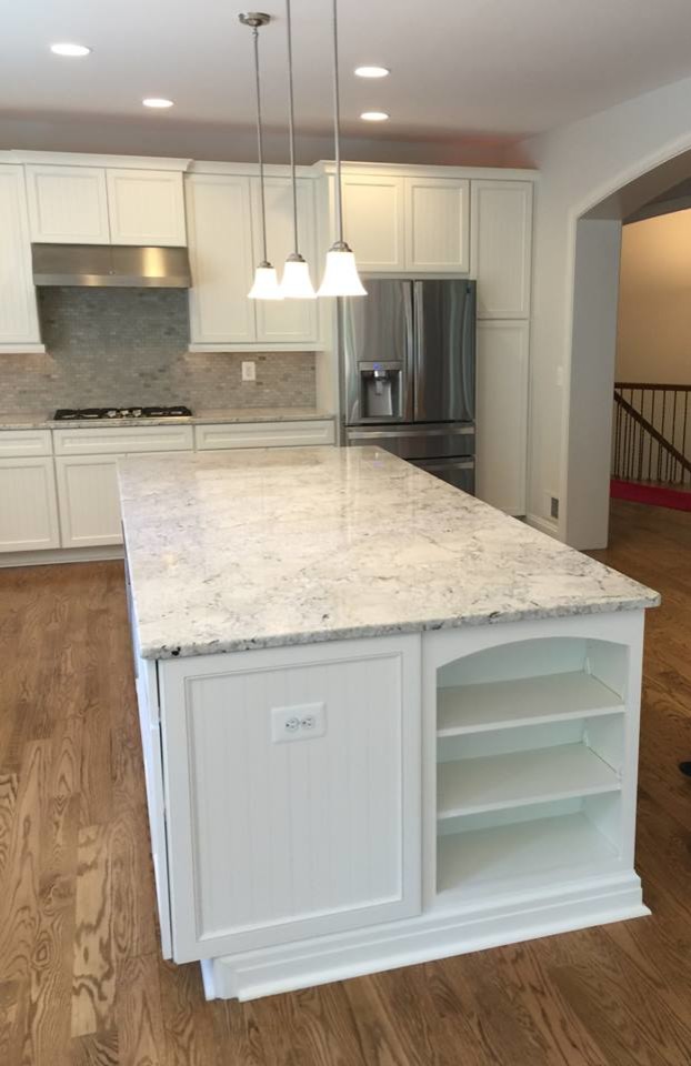 This is an example of a mid-sized arts and crafts galley eat-in kitchen in DC Metro with an undermount sink, beaded inset cabinets, white cabinets, granite benchtops, green splashback, mosaic tile splashback, white appliances, light hardwood floors and with island.