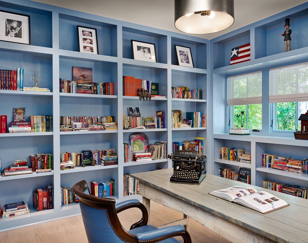 Inspiration for a country home office in Houston with blue walls, a freestanding desk and light hardwood floors.