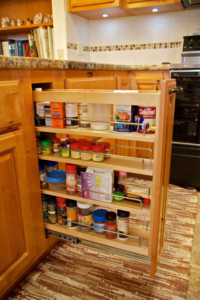 Example of a small u-shaped open concept kitchen design with a drop-in sink, raised-panel cabinets, light wood cabinets, laminate countertops, white backsplash, stainless steel appliances and a peninsula