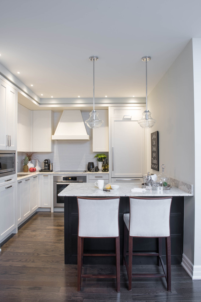 Kitchen - small transitional l-shaped dark wood floor and brown floor kitchen idea in Toronto with shaker cabinets, white cabinets, a peninsula, a double-bowl sink, white backsplash, paneled appliances and gray countertops