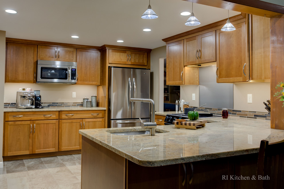 Example of a mid-sized transitional u-shaped porcelain tile enclosed kitchen design in Providence with an undermount sink, shaker cabinets, medium tone wood cabinets, granite countertops, multicolored backsplash, glass tile backsplash, stainless steel appliances and no island