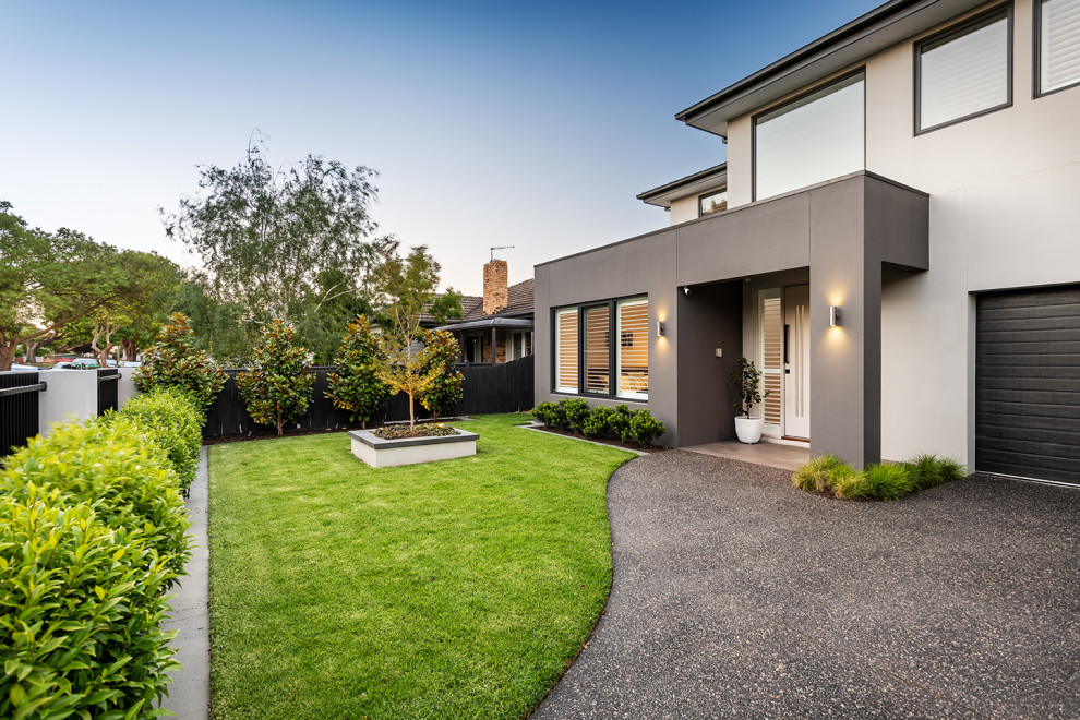 Photo of a mid-sized contemporary front yard driveway in Melbourne with with lawn edging and concrete pavers.