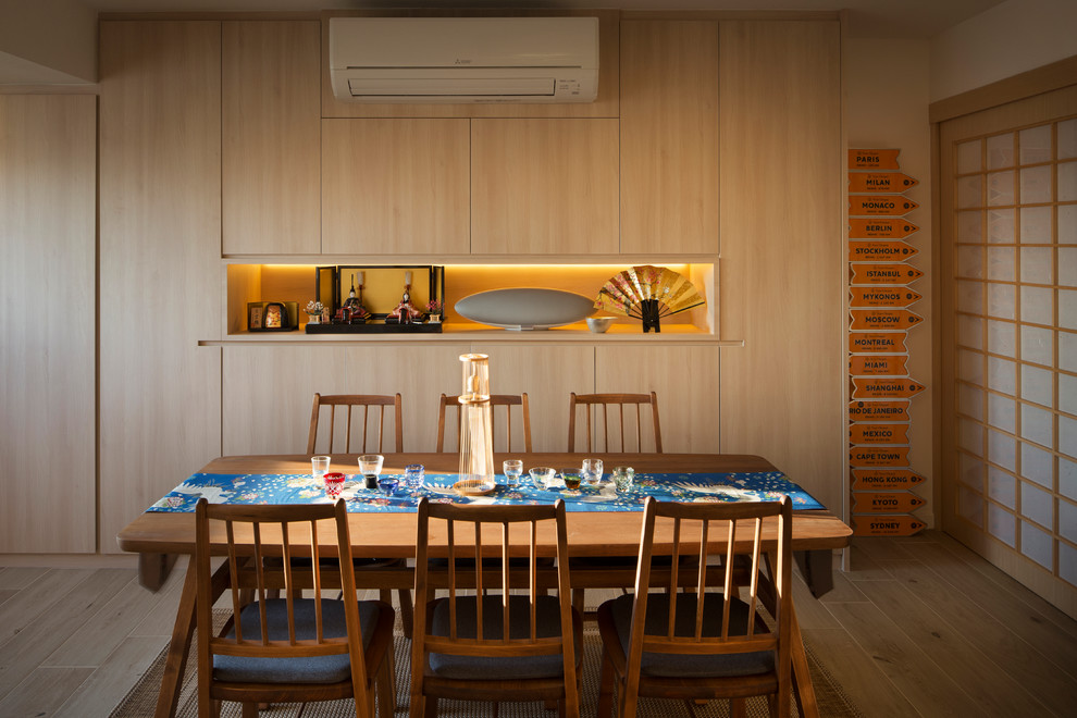 This is an example of an asian separate dining room in Singapore with beige walls, tatami floors and beige floor.