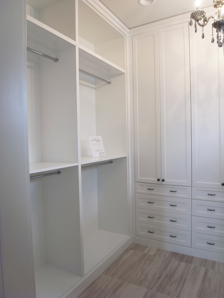 Example of a transitional women's walk-in closet design with white cabinets and flat-panel cabinets