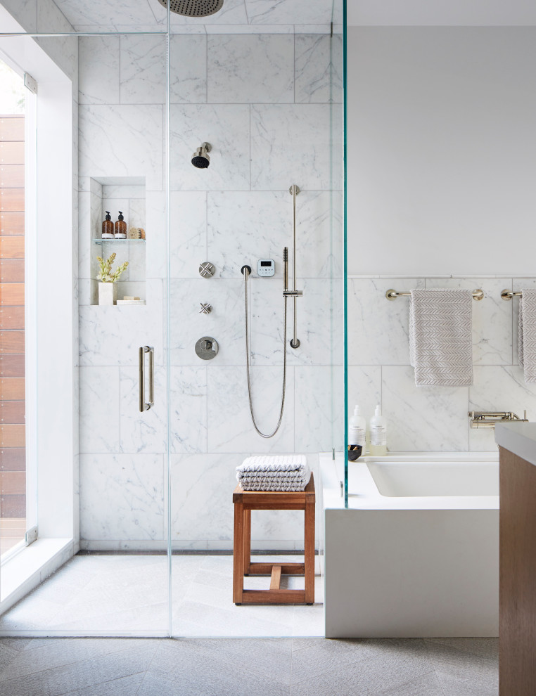 Photo of a large transitional master bathroom in San Francisco with an undermount tub, a corner shower, gray tile, white walls, grey floor, a hinged shower door and a niche.