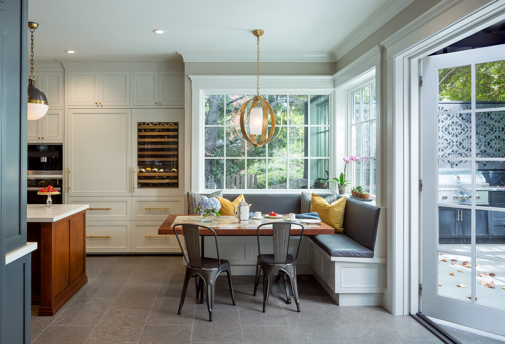 Eat-in kitchen - transitional gray floor eat-in kitchen idea with recessed-panel cabinets, white cabinets, paneled appliances, an island and white countertops