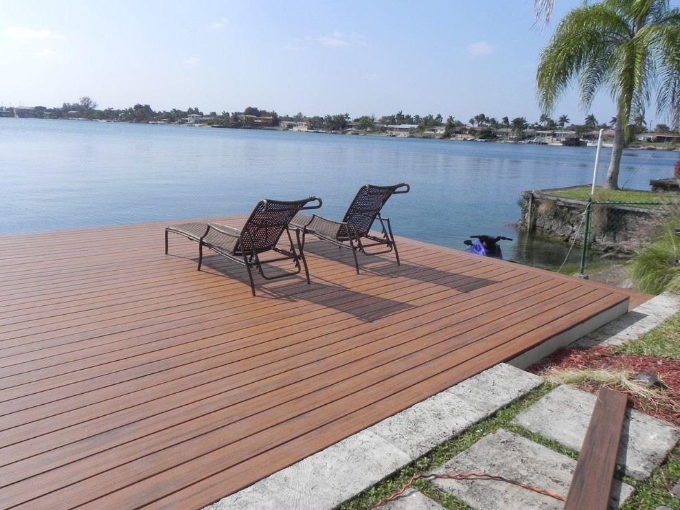 Inspiration for a mid-sized beach style backyard deck in Miami with with dock and no cover.