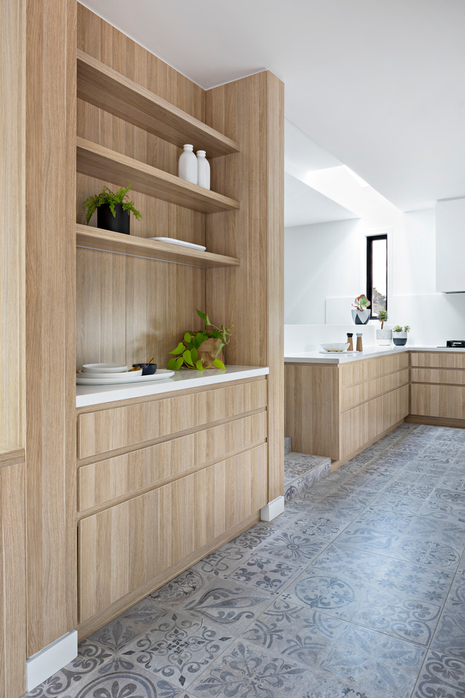 Design ideas for a mid-sized contemporary u-shaped eat-in kitchen in Melbourne with a double-bowl sink, medium wood cabinets, quartz benchtops, white splashback, black appliances and porcelain floors.