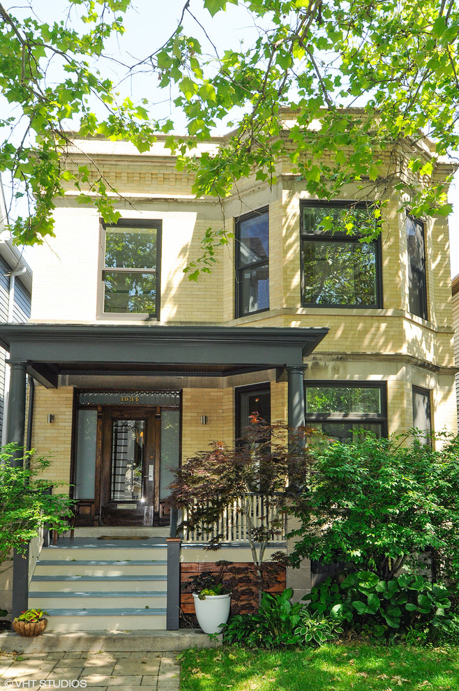 Mid-sized transitional two-storey brick yellow exterior in Chicago.
