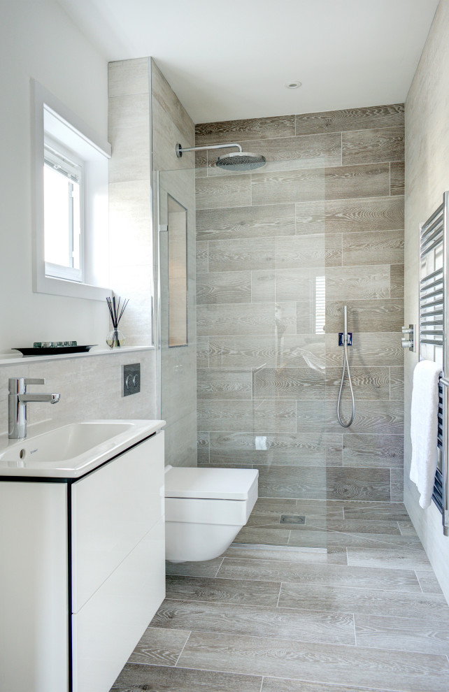 Bathroom - large contemporary master porcelain tile porcelain tile and single-sink bathroom idea in Gloucestershire with flat-panel cabinets, white cabinets, a wall-mount toilet, a wall-mount sink and a floating vanity