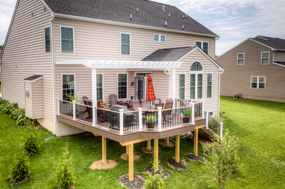 Deck - mid-sized transitional backyard deck idea with a pergola