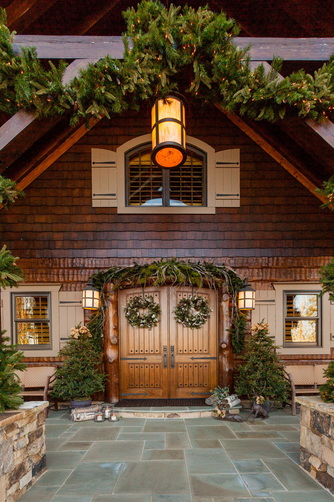 Inspiration for a large country brown house exterior in Atlanta with wood siding.