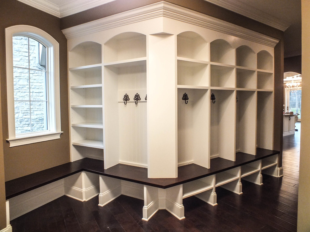 Design ideas for an expansive traditional mudroom in Cleveland with beige walls and dark hardwood floors.