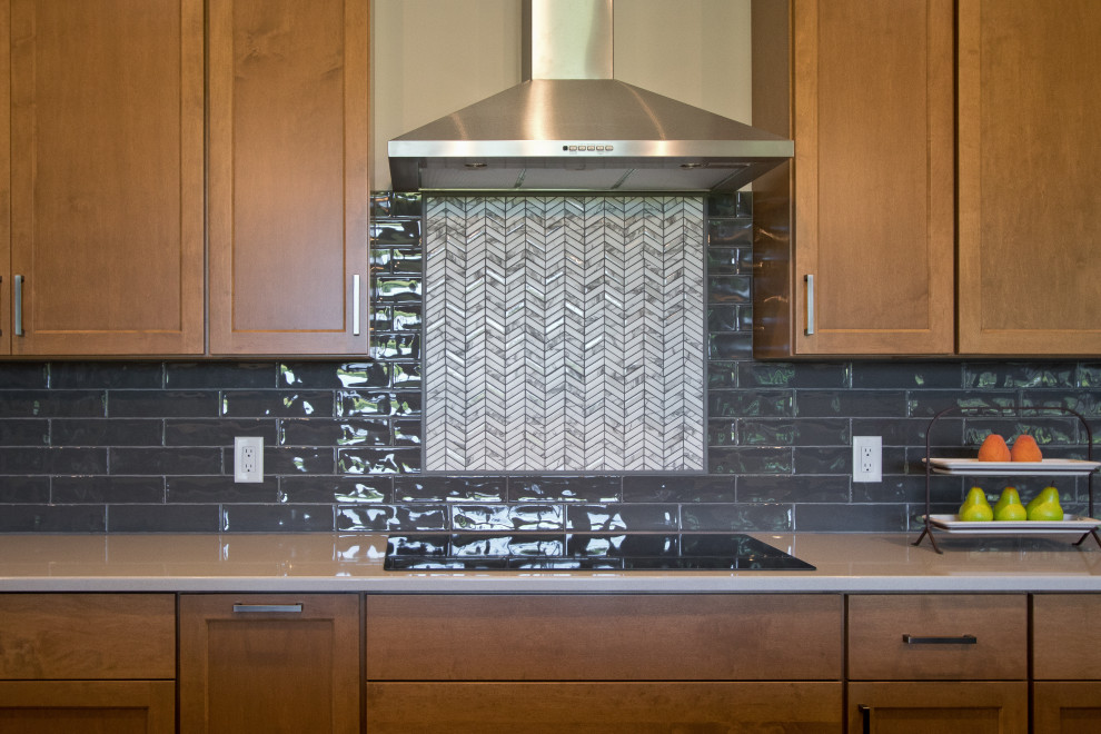 Inspiration for a transitional open concept kitchen remodel with shaker cabinets, medium tone wood cabinets, quartz countertops, gray backsplash, mosaic tile backsplash, stainless steel appliances and white countertops