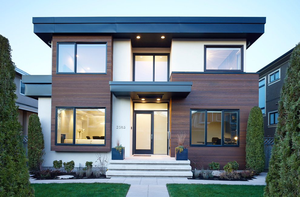 Photo of a contemporary two-storey exterior in Vancouver with a flat roof.