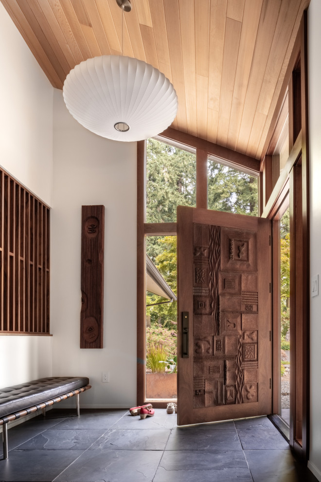 Midcentury foyer in Portland with white walls, a single front door, a medium wood front door, grey floors, a vaulted ceiling and a wood ceiling.