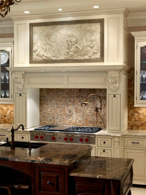 Inspiration for a traditional u-shaped separate kitchen in Chicago with an integrated sink, recessed-panel cabinets, white cabinets, granite benchtops, beige splashback, ceramic splashback, stainless steel appliances, ceramic floors and multiple islands.