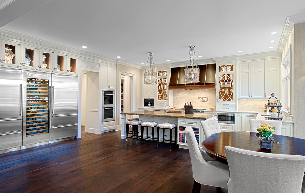 Inspiration for a large transitional dark wood floor and brown floor eat-in kitchen remodel in Chicago with white cabinets, stone slab backsplash, stainless steel appliances, an island, quartz countertops, beige backsplash and recessed-panel cabinets