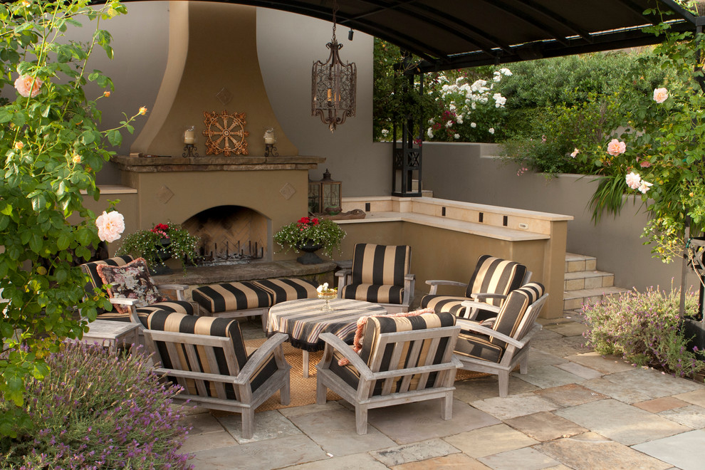 Design ideas for a mid-sized traditional patio in San Francisco with a fire feature, a pergola and natural stone pavers.