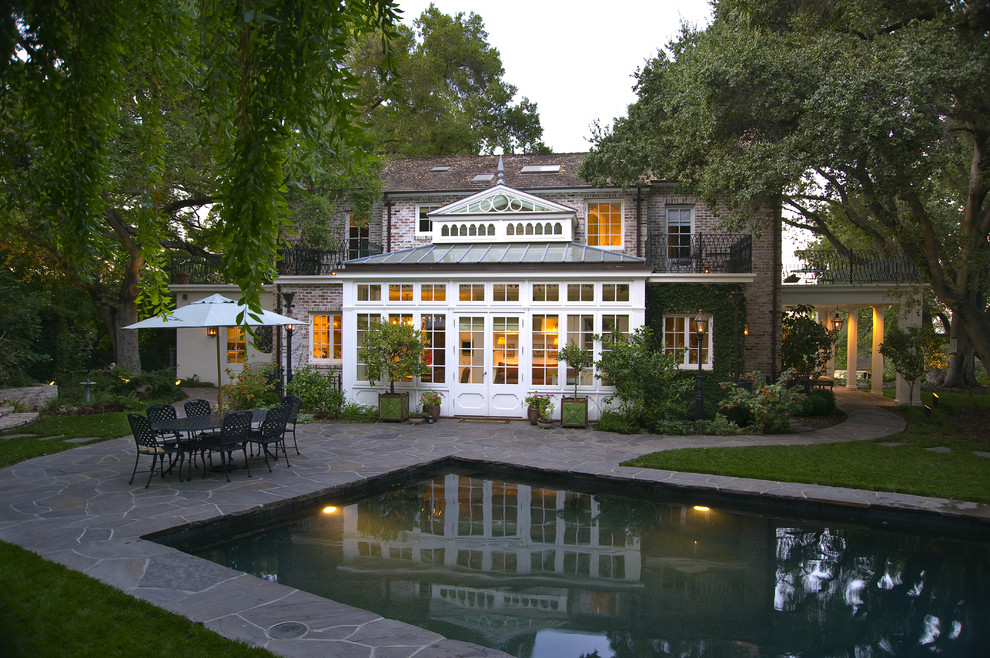 This is an example of a traditional backyard rectangular pool in San Francisco with natural stone pavers.