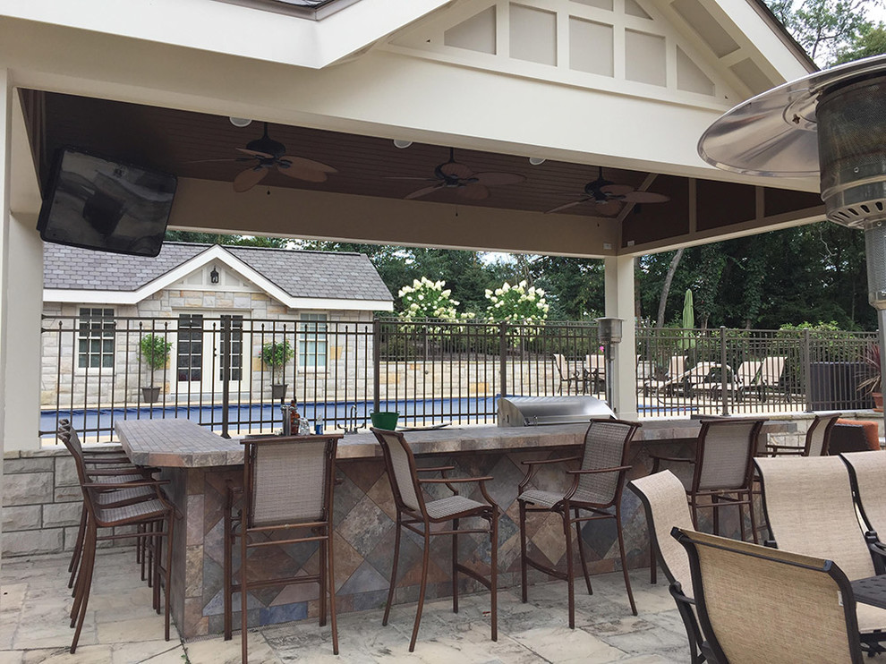 Large transitional backyard patio kitchen photo
