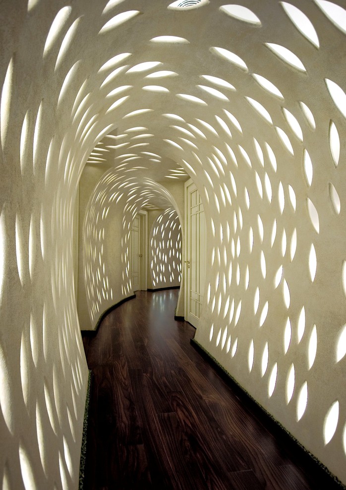 This is an example of a contemporary hallway in Moscow with white walls and medium hardwood floors.