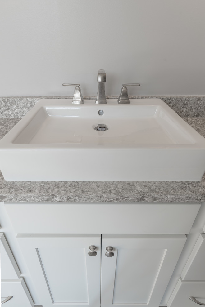 Transitional bathroom photo with shaker cabinets, white cabinets and gray walls