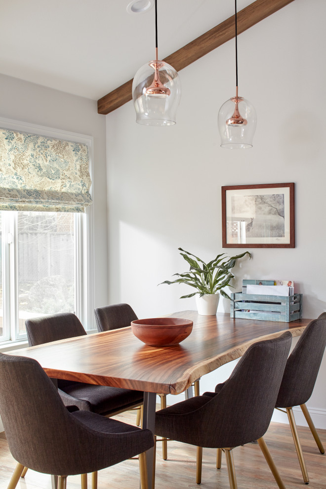 Photo of a mid-sized transitional dining room in San Francisco with white walls, medium hardwood floors, brown floor and exposed beam.