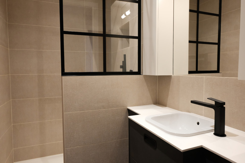 Photo of a small industrial master bathroom in Paris with dark wood cabinets, an open shower, beige tile, ceramic tile, beige walls, cement tiles, an undermount sink, laminate benchtops, black floor, white benchtops, beaded inset cabinets, a two-piece toilet, an open shower, a single vanity and a floating vanity.