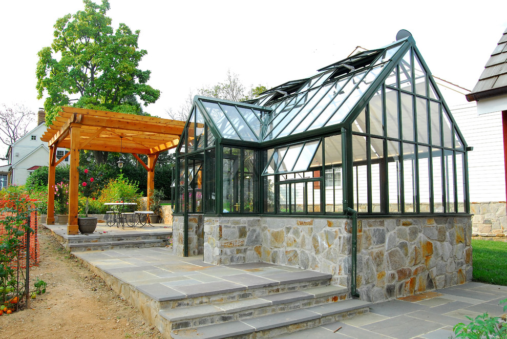 Mid-sized traditional backyard patio in DC Metro with natural stone pavers and a pergola.