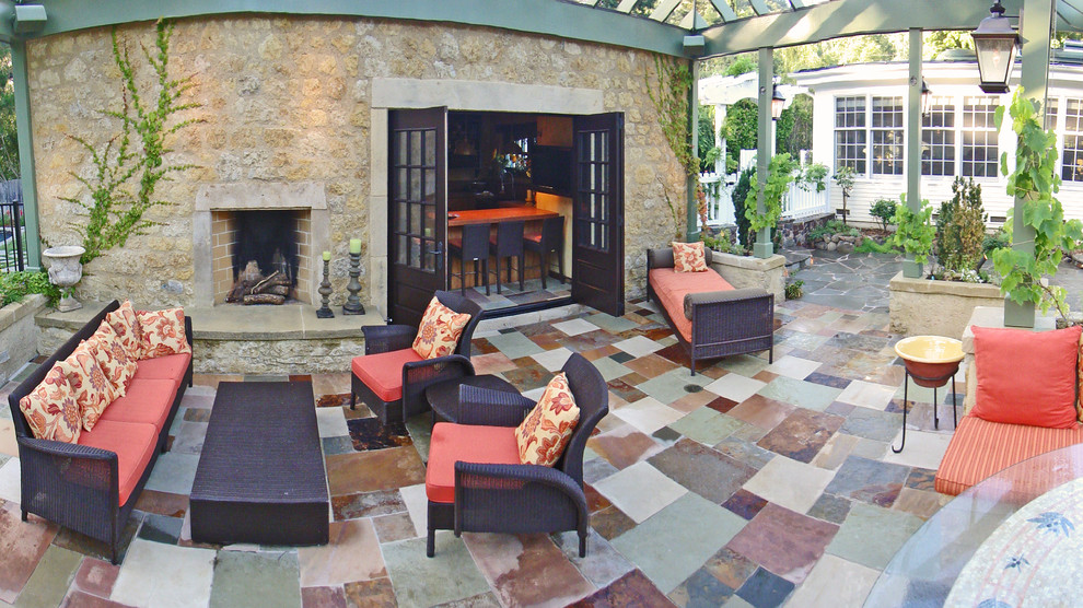 Large mediterranean backyard patio in San Francisco with natural stone pavers, a pergola and a fire feature.