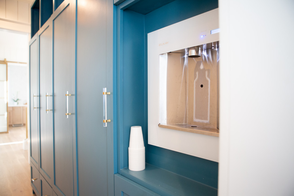 The Cove- Water View Delpino Custom Luxury Coastal Dutch West Indies Style Home - A built-in water bottle filler sits next to the kids lockers and makes for easy access when filling up sports bottles.
