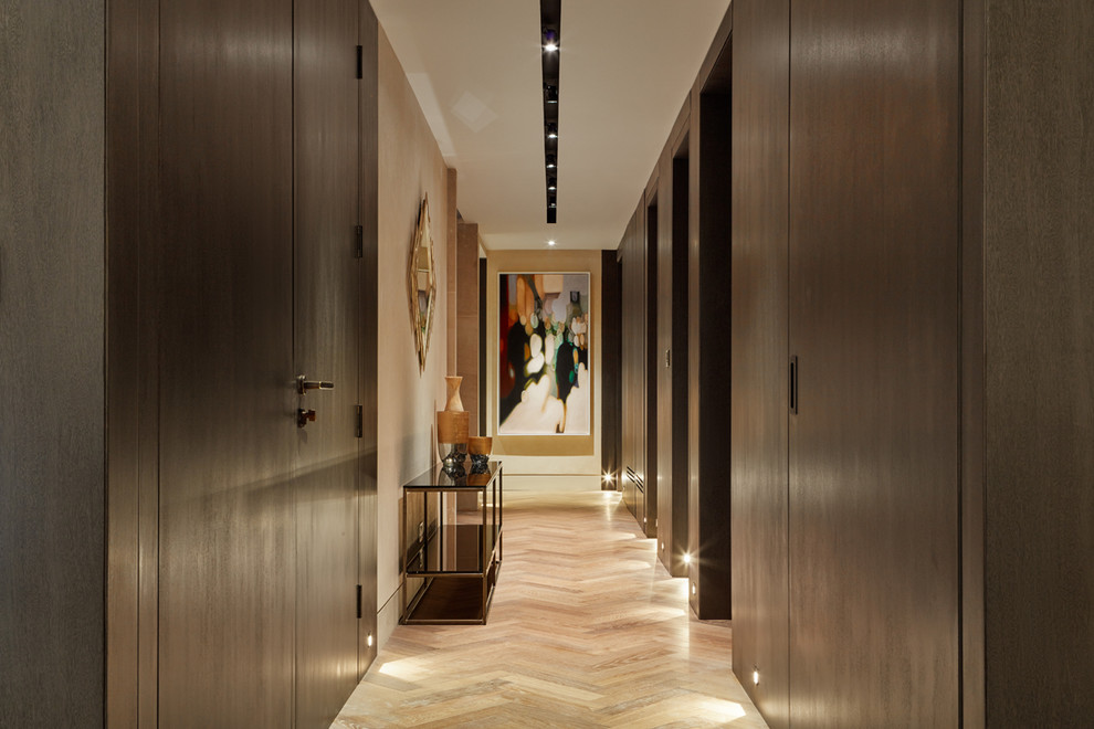 Design ideas for a contemporary hallway in London with brown walls, light hardwood floors and beige floor.