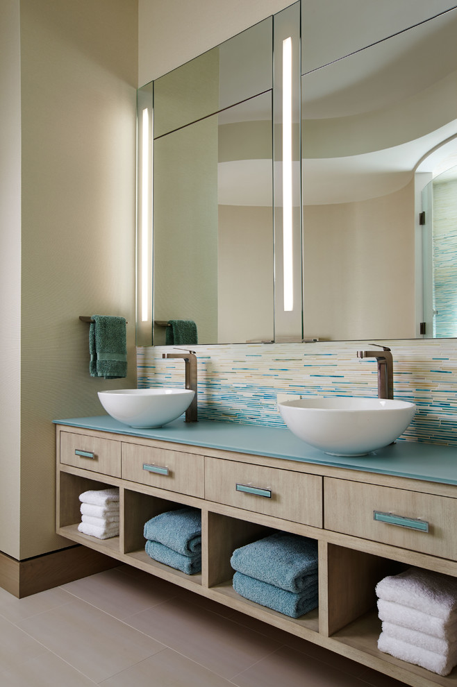 Large contemporary master bathroom in Wichita with a vessel sink, light wood cabinets, multi-coloured tile, mosaic tile, beige walls, a freestanding tub, flat-panel cabinets, blue benchtops, porcelain floors and beige floor.