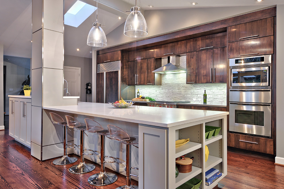 Design ideas for a mid-sized contemporary galley open plan kitchen in Austin with a single-bowl sink, flat-panel cabinets, medium wood cabinets, mosaic tile splashback, stainless steel appliances, quartz benchtops, grey splashback, medium hardwood floors and with island.