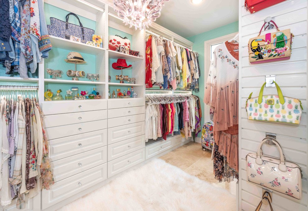 This is an example of a large modern women's walk-in wardrobe in Other with raised-panel cabinets and white cabinets.