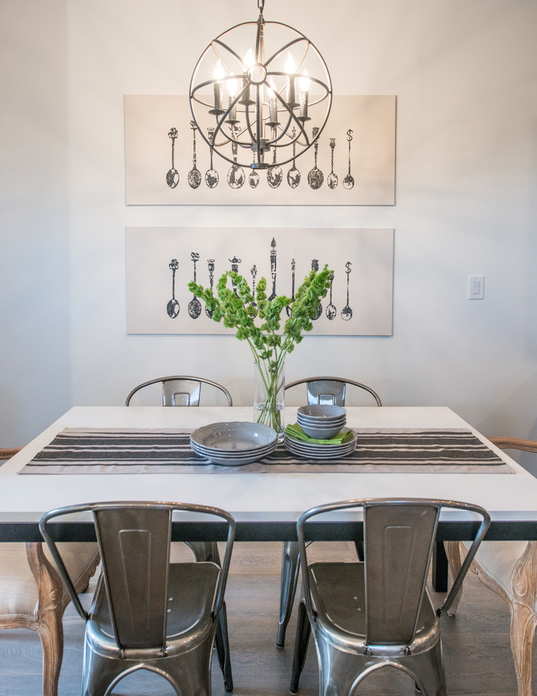 Photo of a transitional dining room in Calgary with white walls.