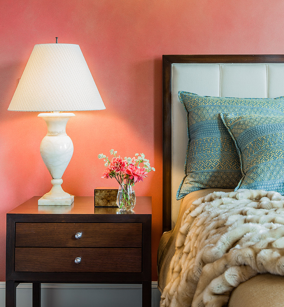 This is an example of a large eclectic master bedroom in Boston with pink walls.