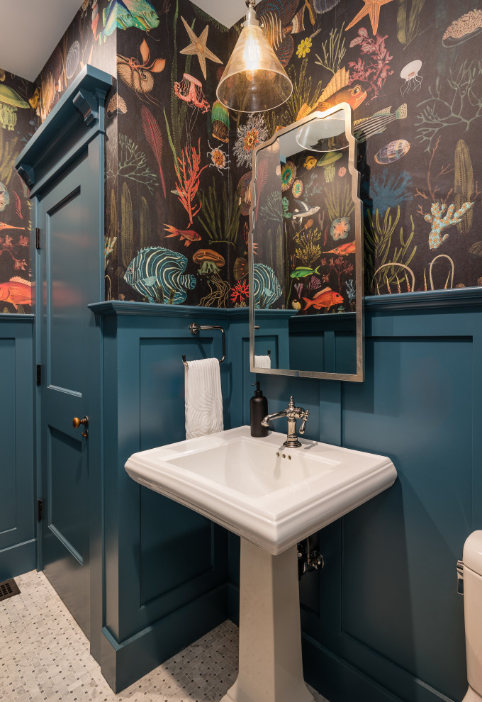 This is an example of a small classic cloakroom in Los Angeles with multi-coloured walls, a pedestal sink, multi-coloured floors and wainscoting.