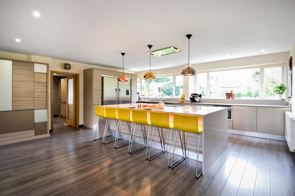 Design ideas for a contemporary kitchen in West Midlands with flat-panel cabinets, medium wood cabinets, stainless steel appliances, with island and dark hardwood floors.