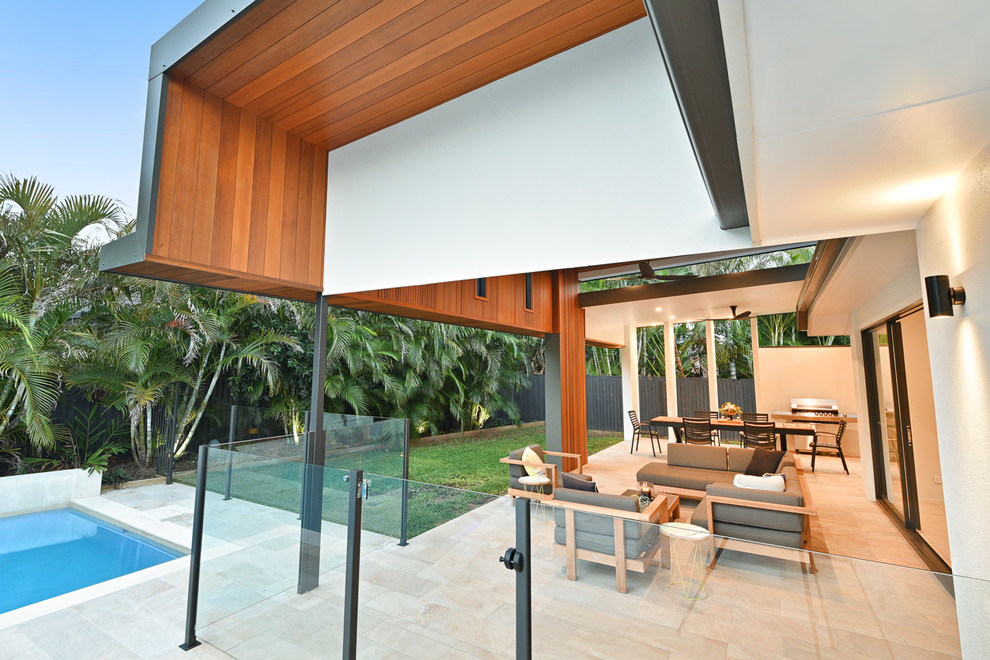 Photo of a mid-sized contemporary backyard patio in Brisbane with tile and a roof extension.