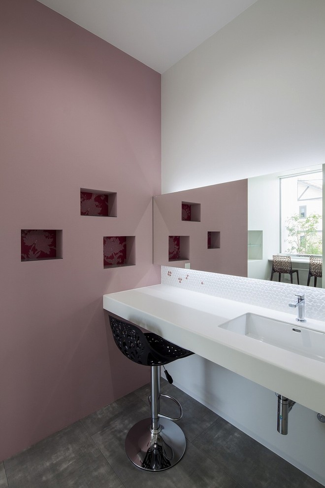 This is an example of a modern powder room in Other with purple walls.